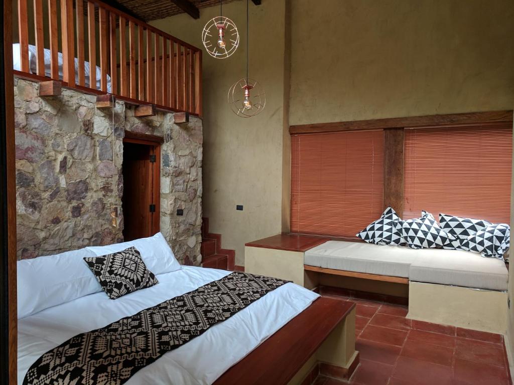 Postel nebo postele na pokoji v ubytování Mamaq Tambo Lodge