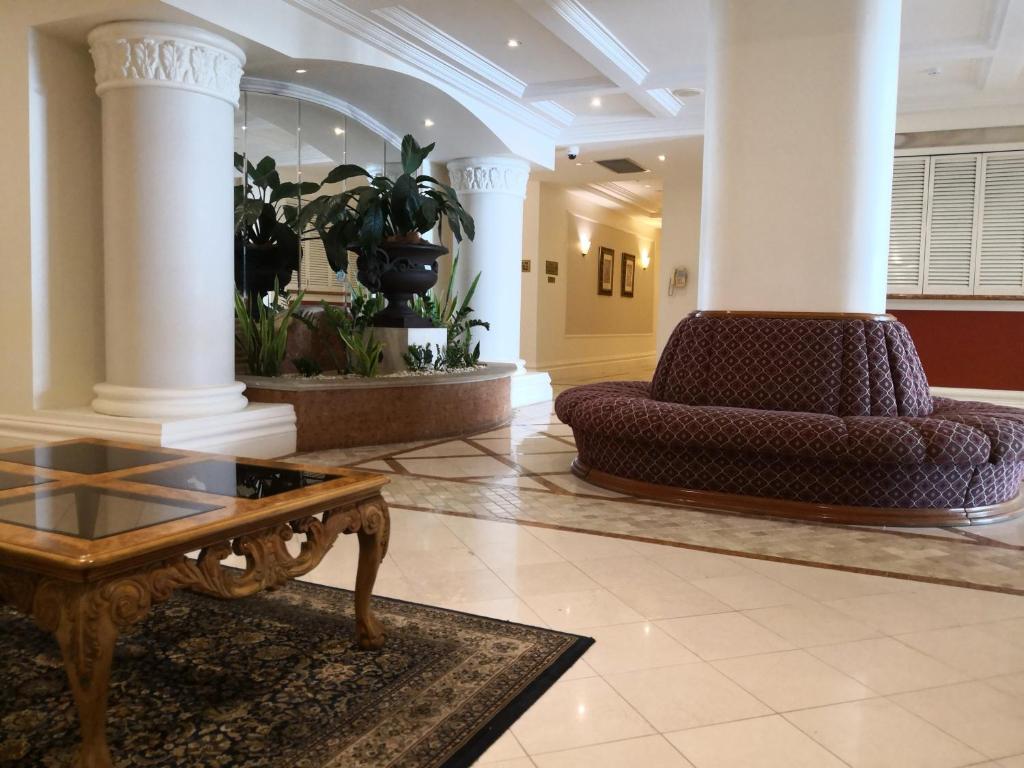 a lobby with a couch and a coffee table at Broadbeach in Gold Coast
