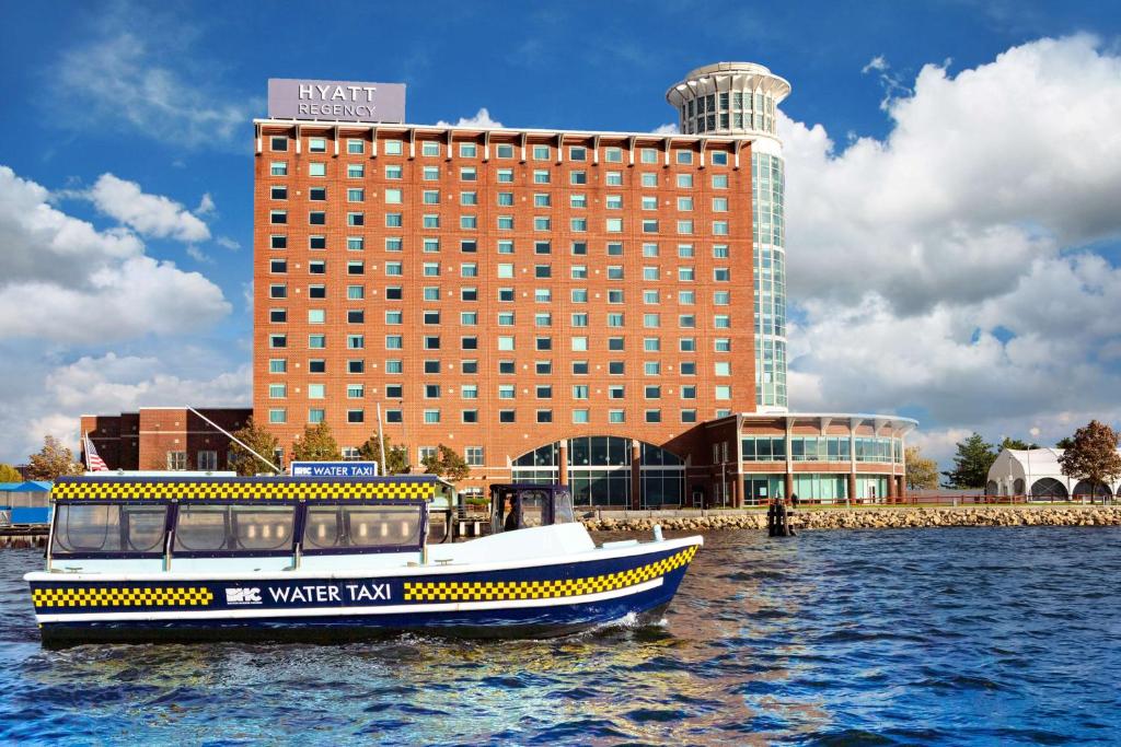 a boat in the water in front of a building at Hyatt Regency Boston Harbor in Boston