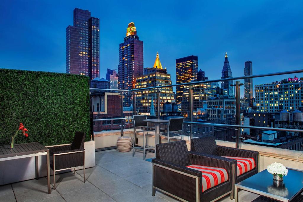 a rooftop patio with a view of the city at Hyatt Herald Square New York in New York