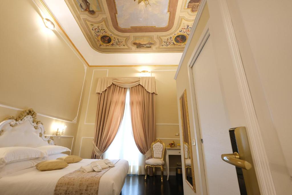 a bedroom with two beds and a window at B&B Kingsman in Florence