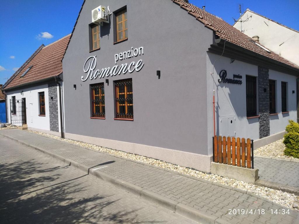 a white building on the side of a street at Penzion Romance in Břeclav