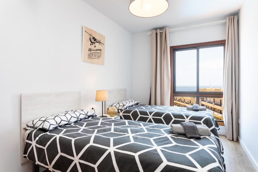 Posteľ alebo postele v izbe v ubytovaní Home2Book Amazing Sea View El Médano Pool & Wifi