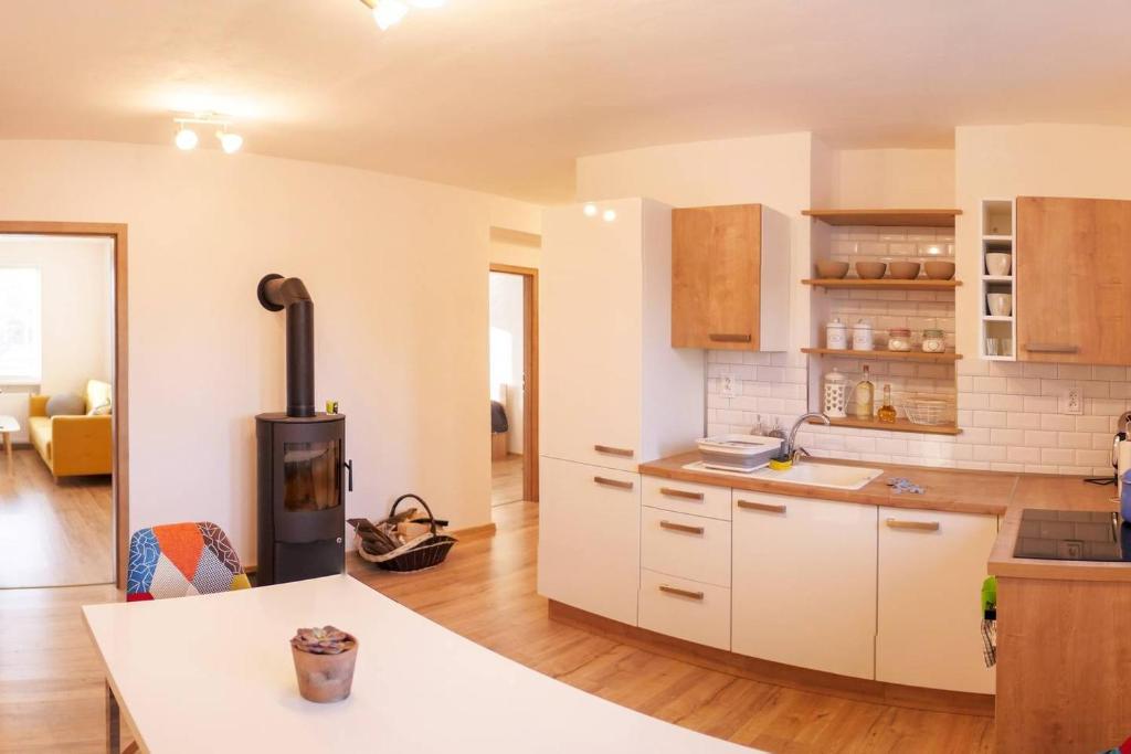 a kitchen with white cabinets and a stove at 2 bedroom flat in the heart of Liptovsky Mikulas in Liptovský Mikuláš