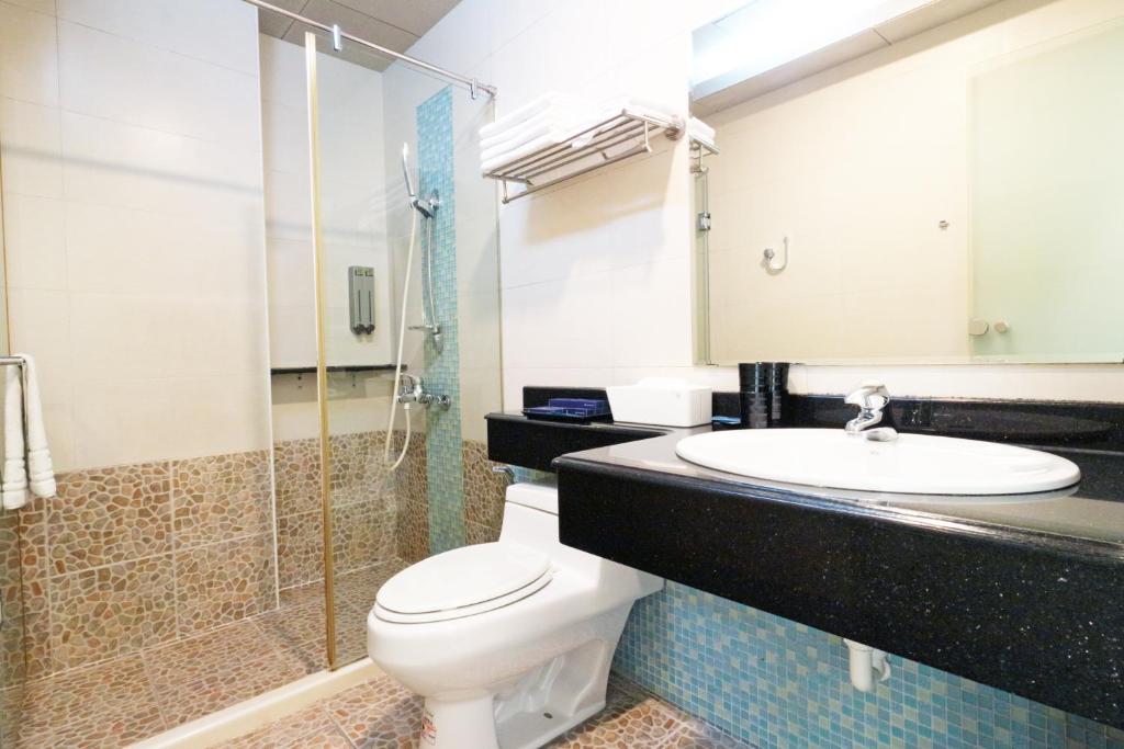 a bathroom with a toilet and a sink and a shower at 36 Lighthouse in Hualien City