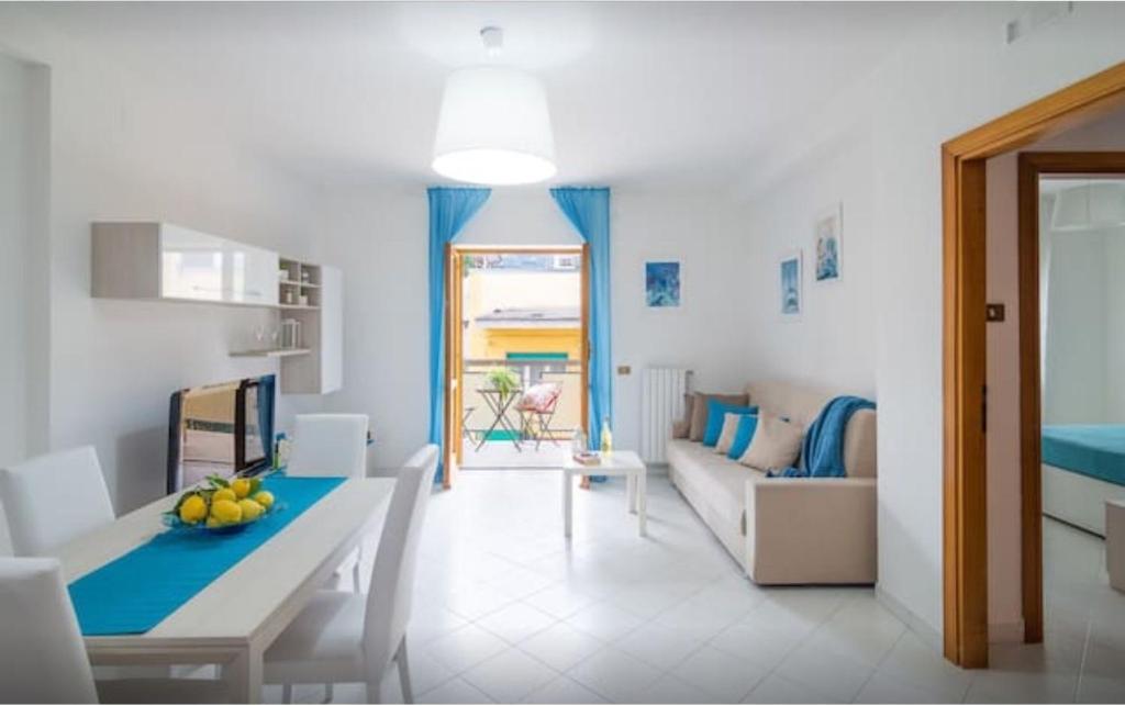 a kitchen and living room with a table and a couch at Maison Eva in Sorrento