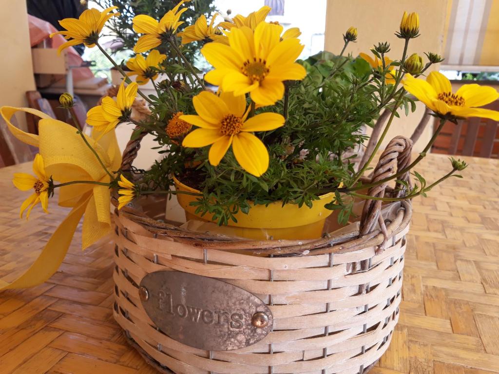a basket filled with yellow flowers on a table at Flowery House in Rome