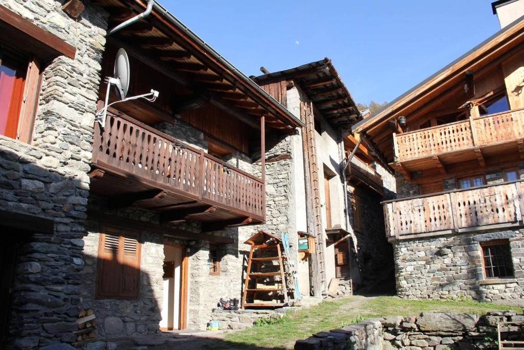 a building with wooden balconies on the side of it at Chalet Fr Gilkens Arc 1600 in Bourg-Saint-Maurice