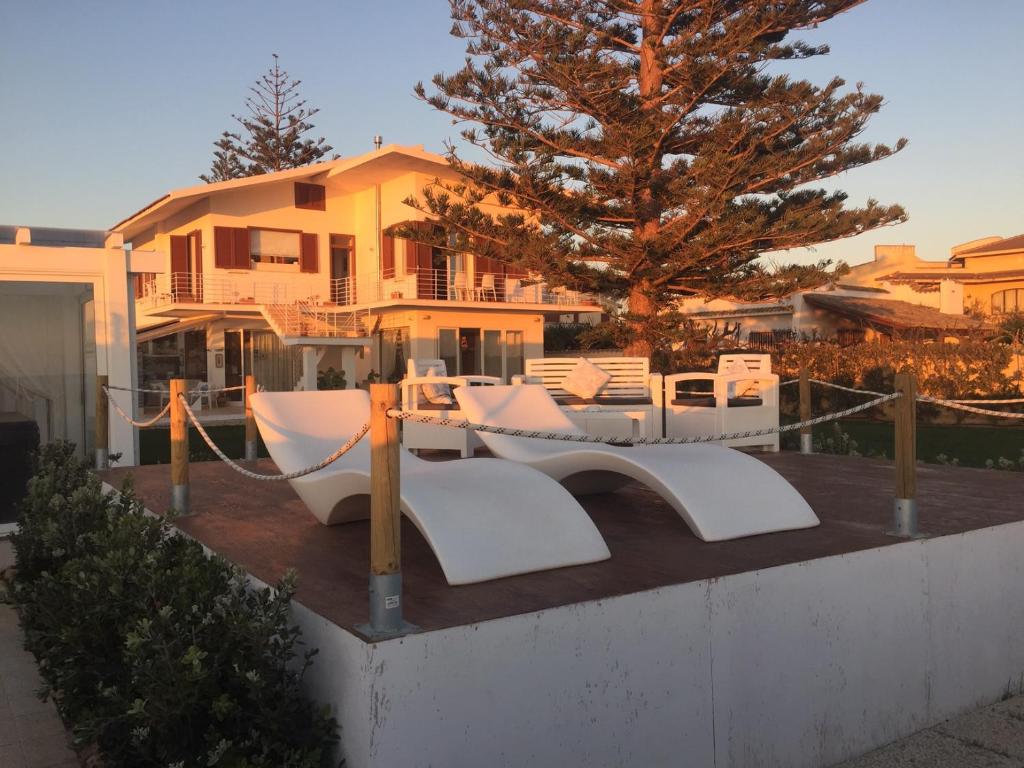 a house with a table and chairs in front of it at SUITEBEACH b&b and resort in Marsala