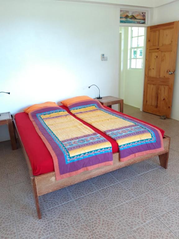 Postel nebo postele na pokoji v ubytování Mango Garden Cottages