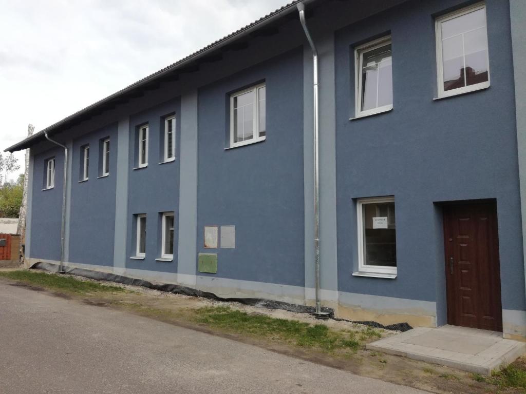 un edificio azul con una puerta a un lado en Apartmán Prefa en Benešov nad Ploučnicí