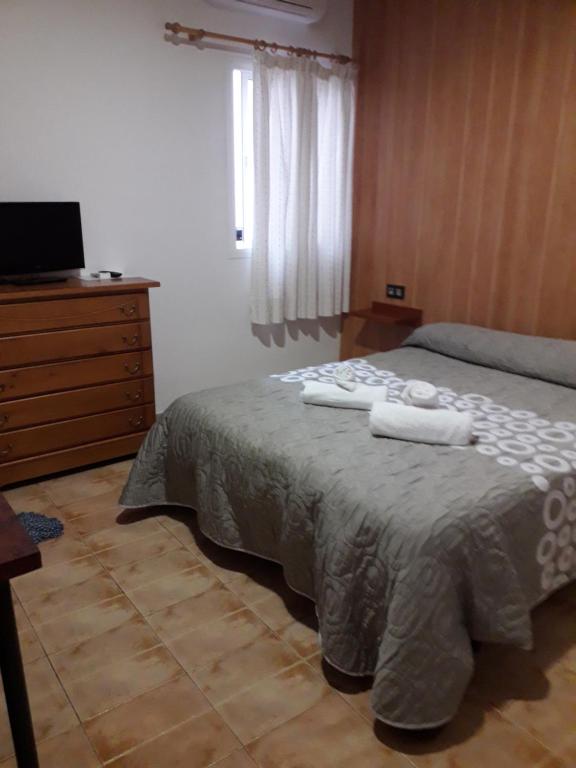 Posteľ alebo postele v izbe v ubytovaní Hostal Virgen Del Pilar