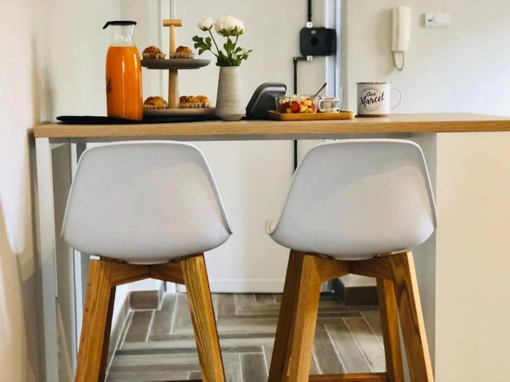 two white chairs sitting under a counter in a kitchen at Sciri Suite #2 in Perugia