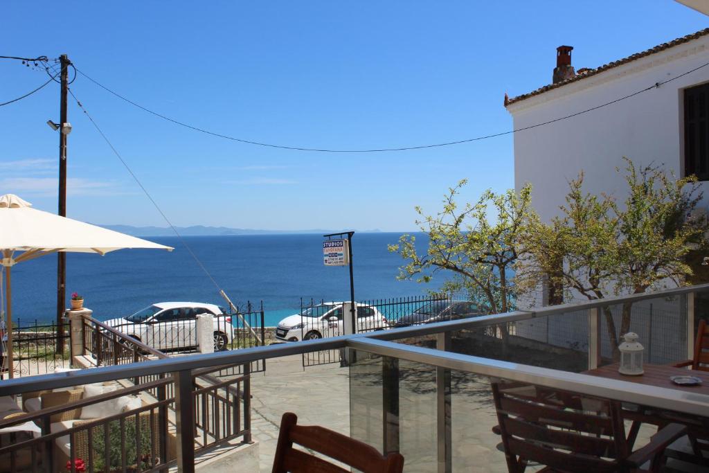 a balcony of a restaurant with a view of the ocean at panorama studios in Afitos