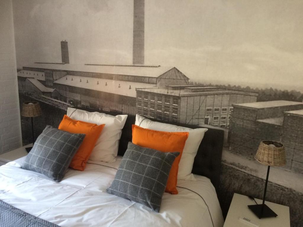 a bedroom with a bed with a painting on the wall at Villa van Brienen in Dilsen-Stokkem