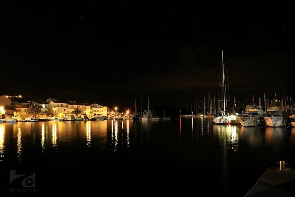 a group of boats docked in a harbor at night at Villa Ines in Jezera