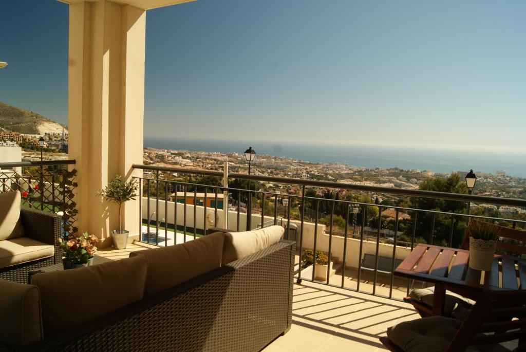 a balcony with a couch and a view of the ocean at Casa Joca Pueblo in Benalmádena
