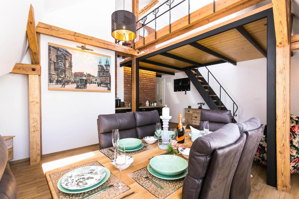 a dining room with a table and leather chairs at The Old Town Square & Parizska Apartments in Prague