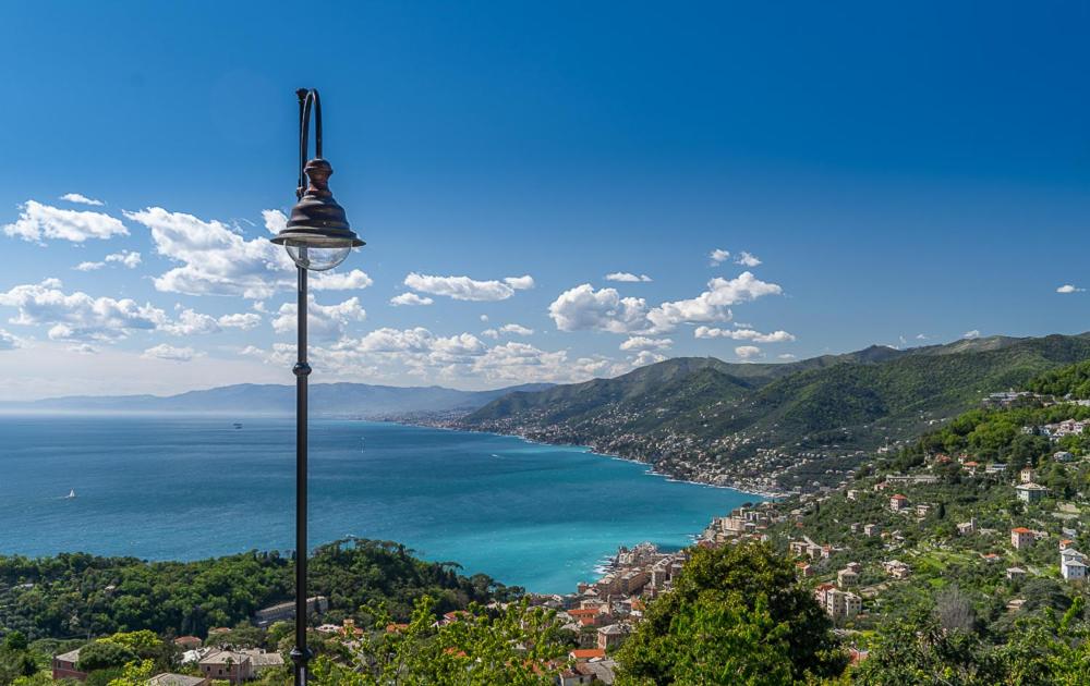 a street light next to a body of water at Portofino House in Camogli