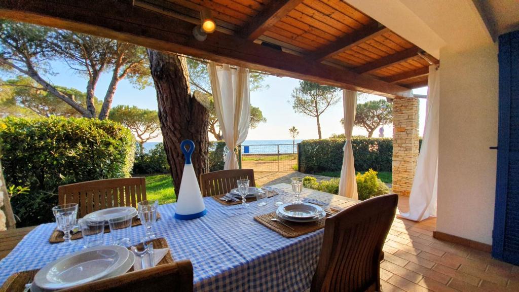 a table with a blue and white table cloth on a patio at Mediterranean Beach House in Umag