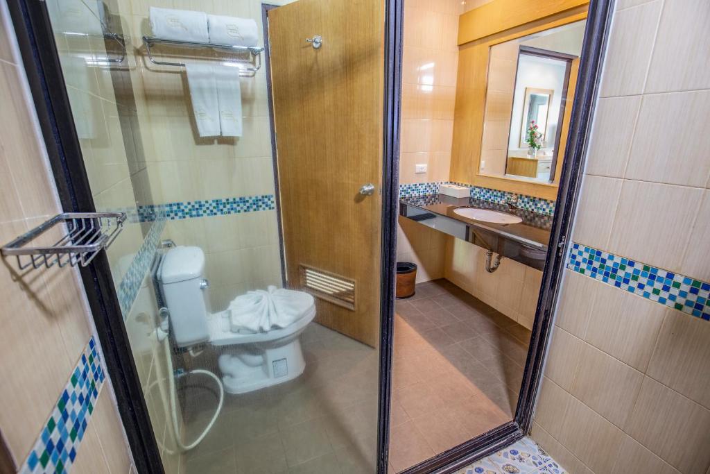 a bathroom with a toilet and a shower and a sink at Sungthong Kamala Beach Resort in Kamala Beach