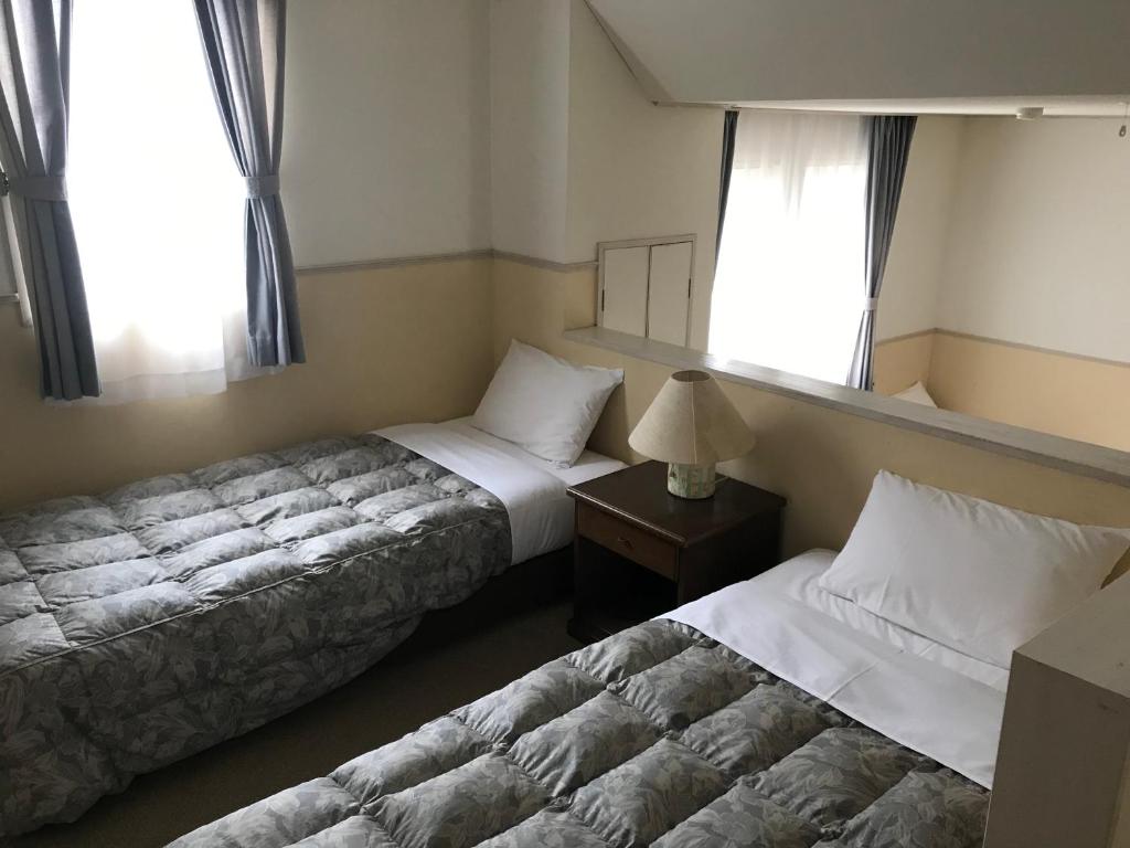 Postel nebo postele na pokoji v ubytování Petit Hotel Kurumi to Milk