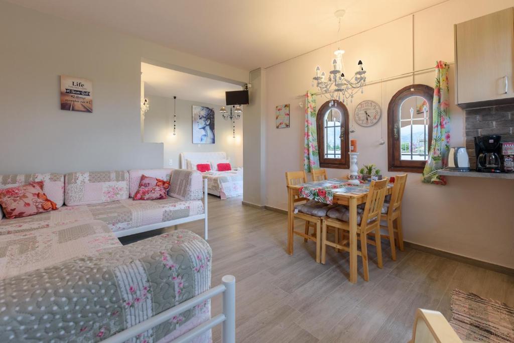 a living room with a couch and a dining room at Olympus Studios in Malia