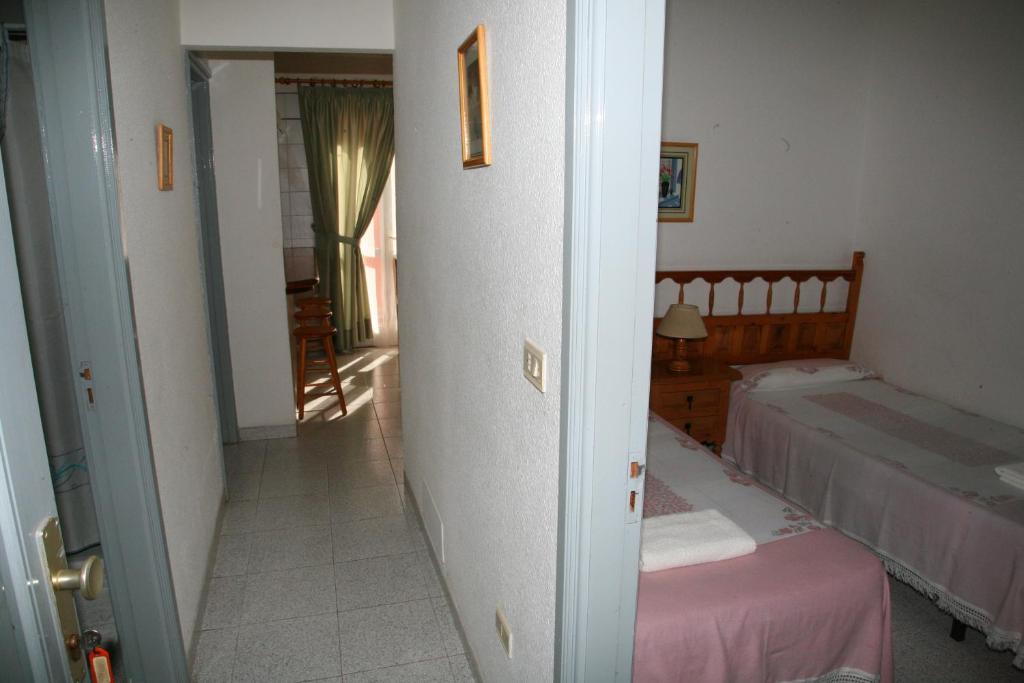 A bed or beds in a room at Apartamentos San Sebastián