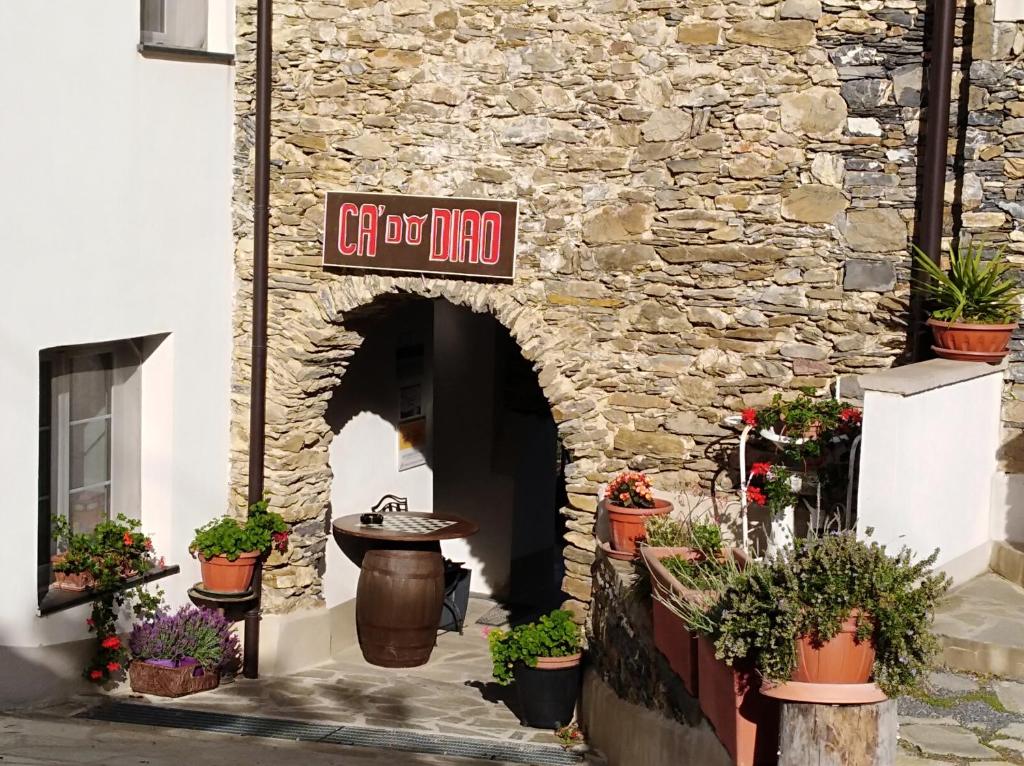 a stone building with a sign for a gift shop at Ca' Do Diao in Onzo