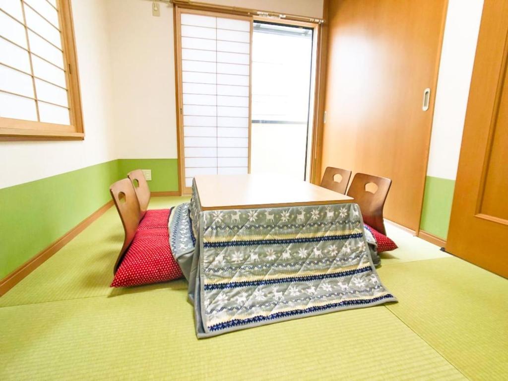 a table in a room with two chairs and a table at Triphome Ikebukuro Tokyo Max 7ppls FREE WIFI in Tokyo