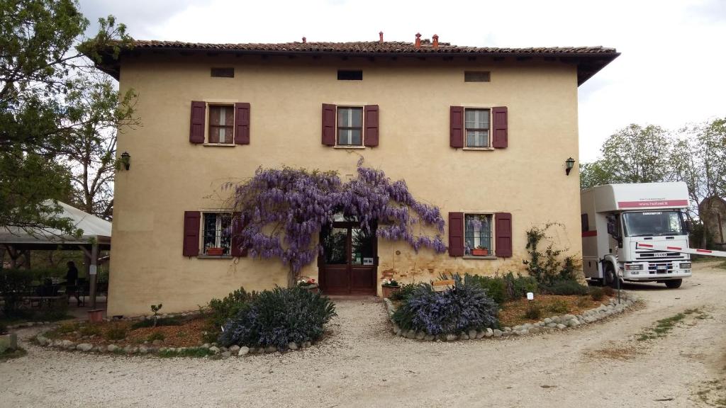 a house with a truck parked in front of it at Agriturismo Montevecchio Isolani in Monte San Pietro