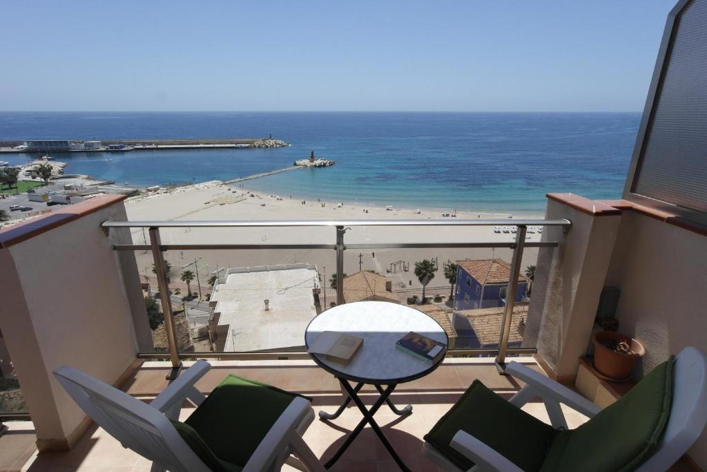 a balcony with chairs and a table and the ocean at MB, Mareta Blava, piscina y vistas in Era de Soler