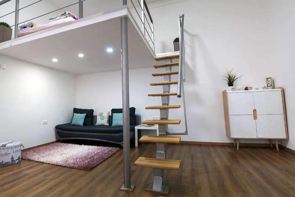 a living room with a loft bed and a staircase at W&ouml;r&ouml;smarty Studio - Budapest Center in Budapest