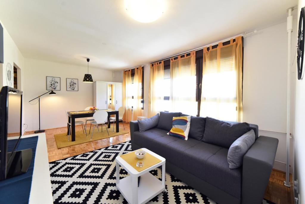 a living room with a couch and a table at Apartment Place4U in Zagreb
