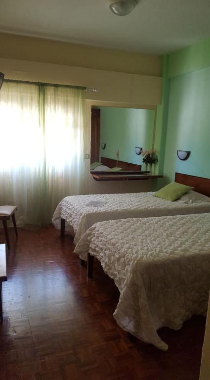 Postel nebo postele na pokoji v ubytování Aparthotel Avenida