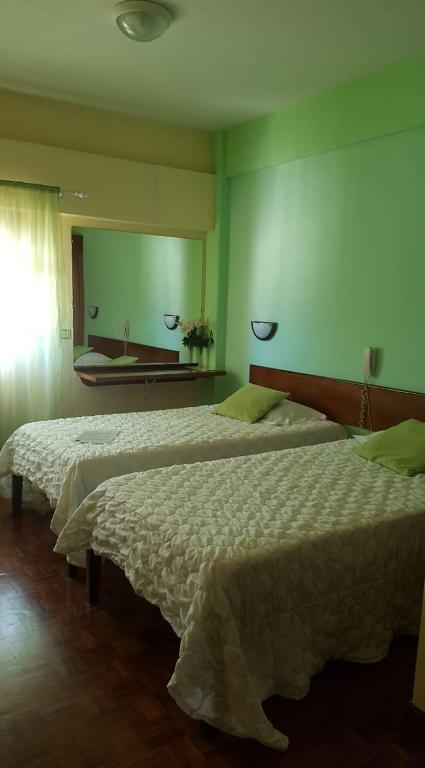Postel nebo postele na pokoji v ubytování Aparthotel Avenida