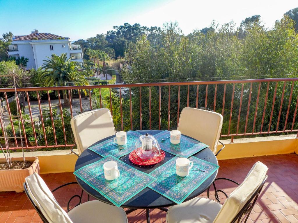 a table and chairs on a balcony with a view at Apartment Boulouris Mimosa by Interhome in Saint-Raphaël