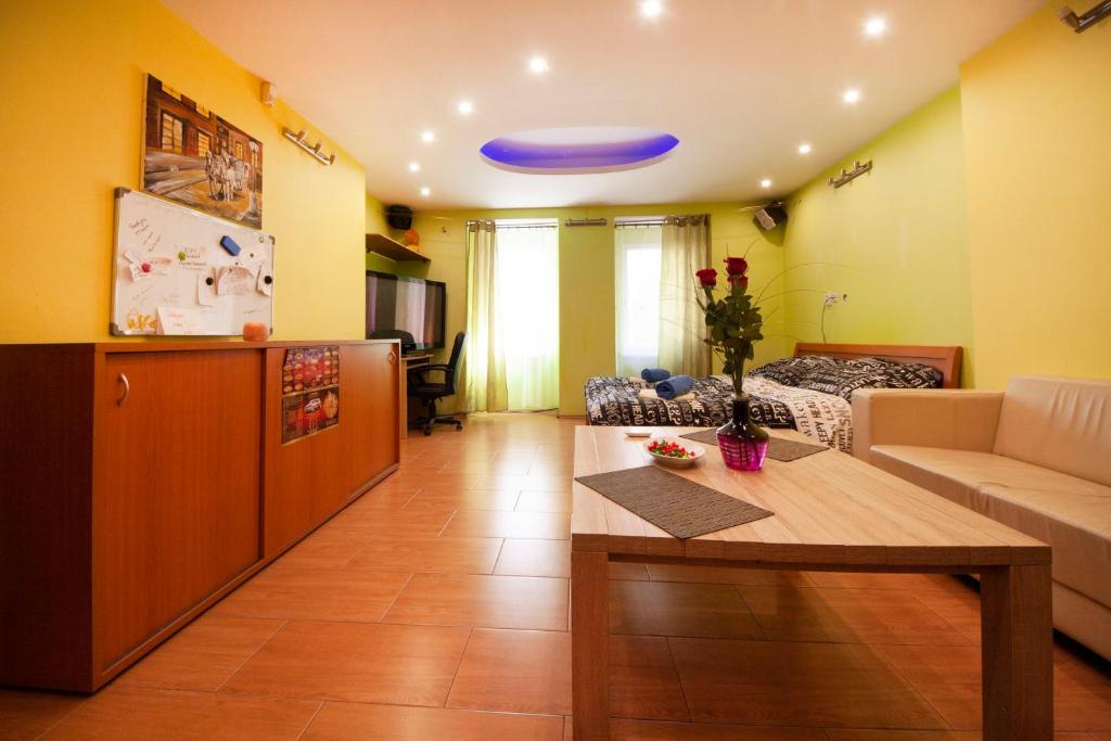 a living room with a table and a blue frisbee at center of Bratislava with jacuzzi in Bratislava
