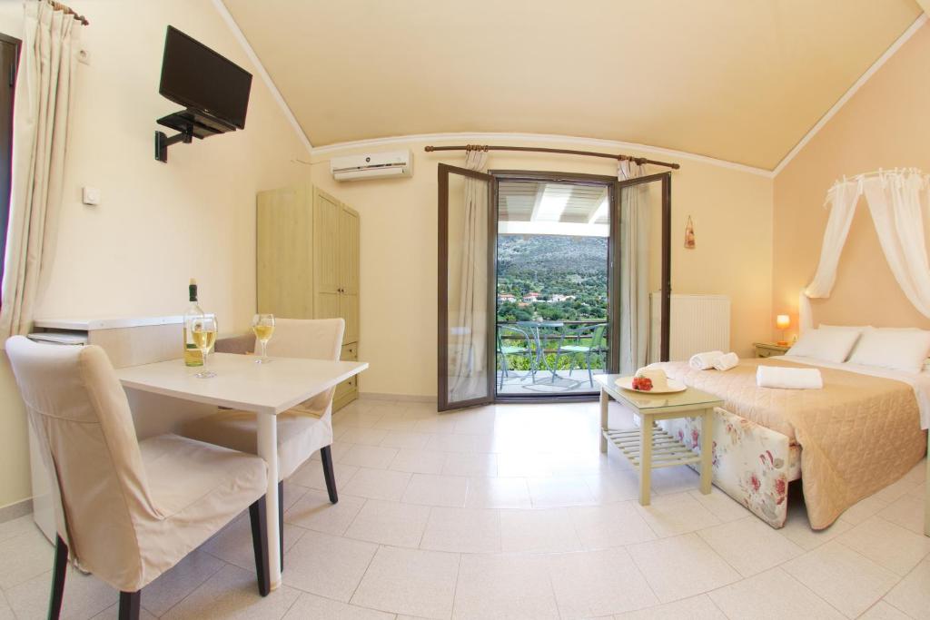 a living room with a bed and a table and a room at Minas Apartments in Divarata