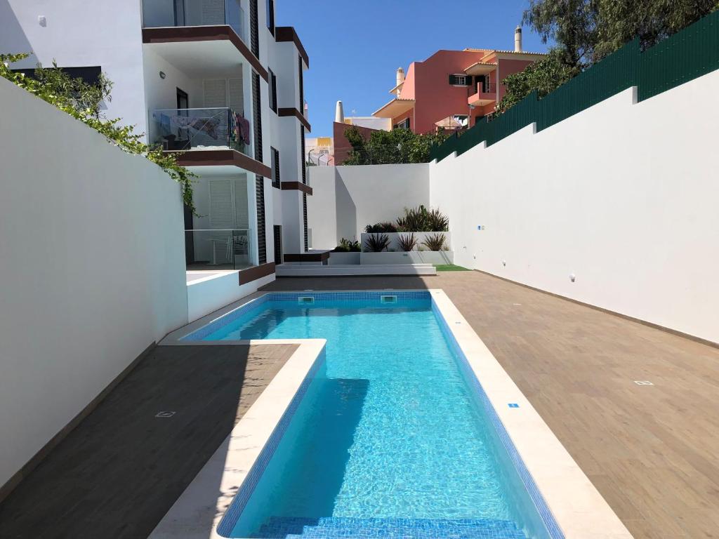 a swimming pool in the backyard of a house at Rera Alvor Deluxe Apartments in Alvor