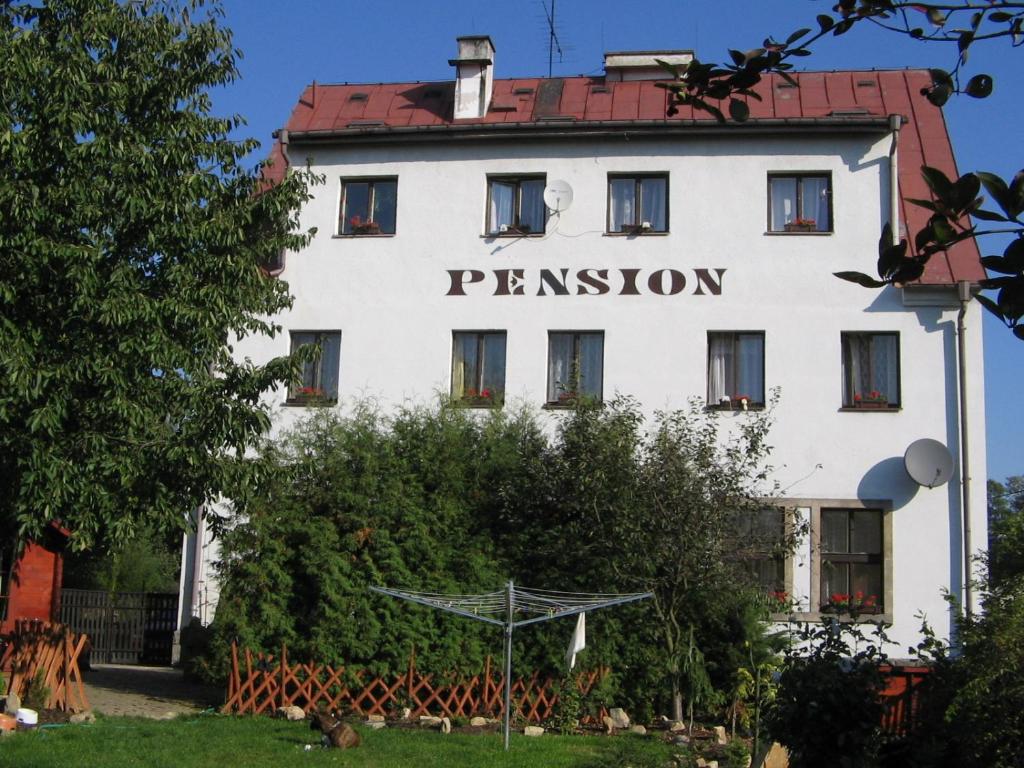 a white building with the word permission on it at Pension Doctor in Dvůr Králové nad Labem