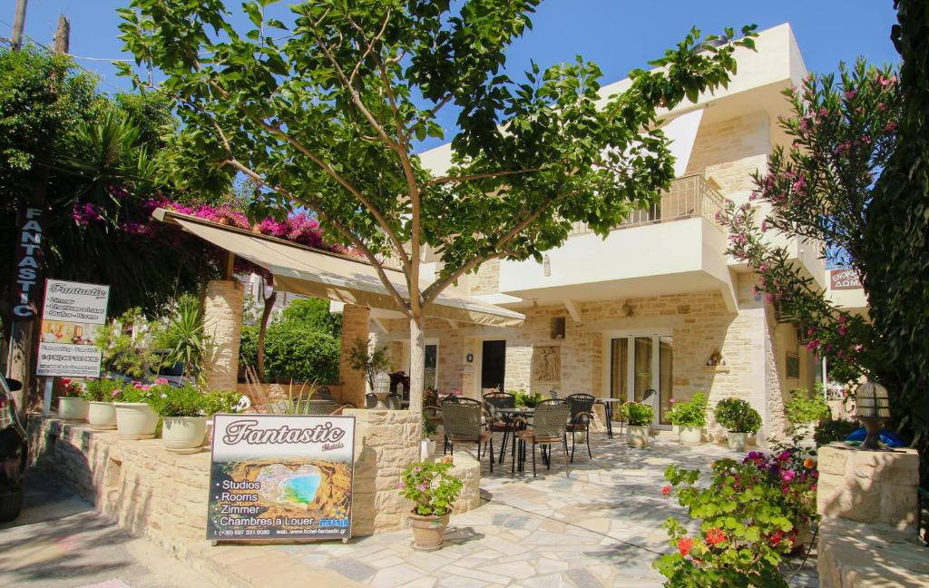 a patio of a house with a table and chairs at Fantastic Matala 2 in Matala