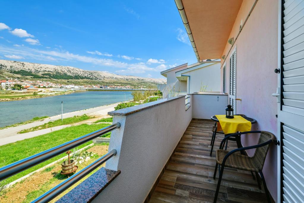 a balcony with a table and a view of the water at Apartments Rija in Pag