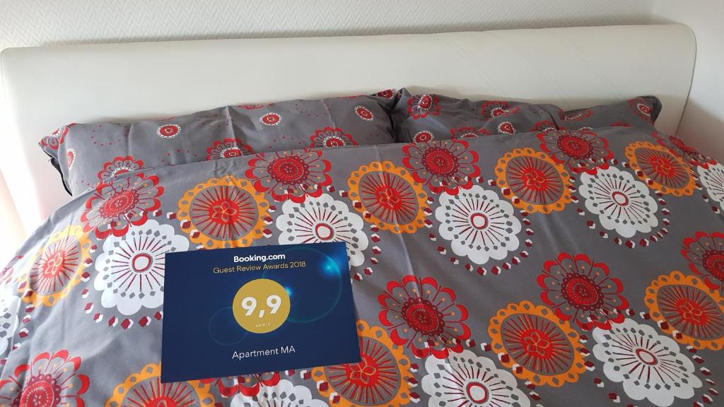 a bed with a blanket with a on it at Apartment MA in Banja Luka