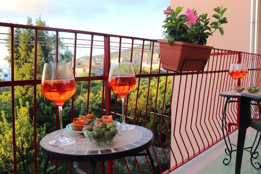 due bicchieri di vino su un tavolo sul balcone di Painter House a Sant'Agnello