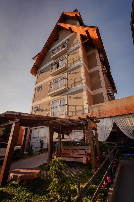 a large building with balconies on the side of it at Villa di Cavi Hotel in Gramado
