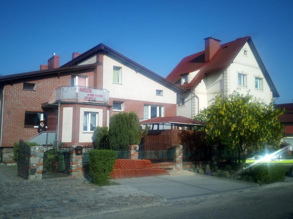 a large brick house with a sign on it at Mieszkanie na zielonej in Człuchów