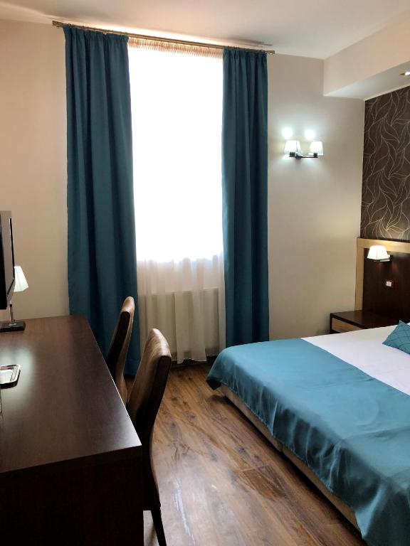 Postel nebo postele na pokoji v ubytování Pensiunea Lido