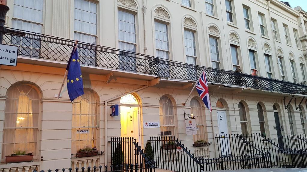 a building with two flags in front of it at Andorra Guest Accommodation in Brighton & Hove