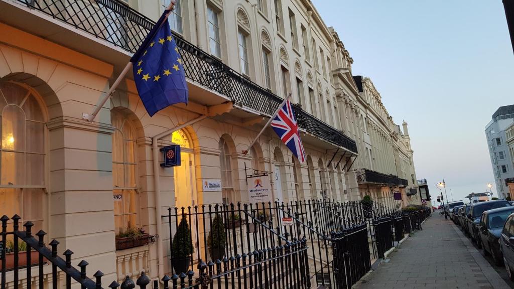 two british flags on the side of a building at Andorra Guest Accommodation in Brighton & Hove